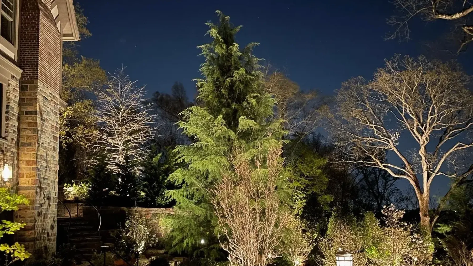 Custom landscape lighting on a Franklin, TN home at night
