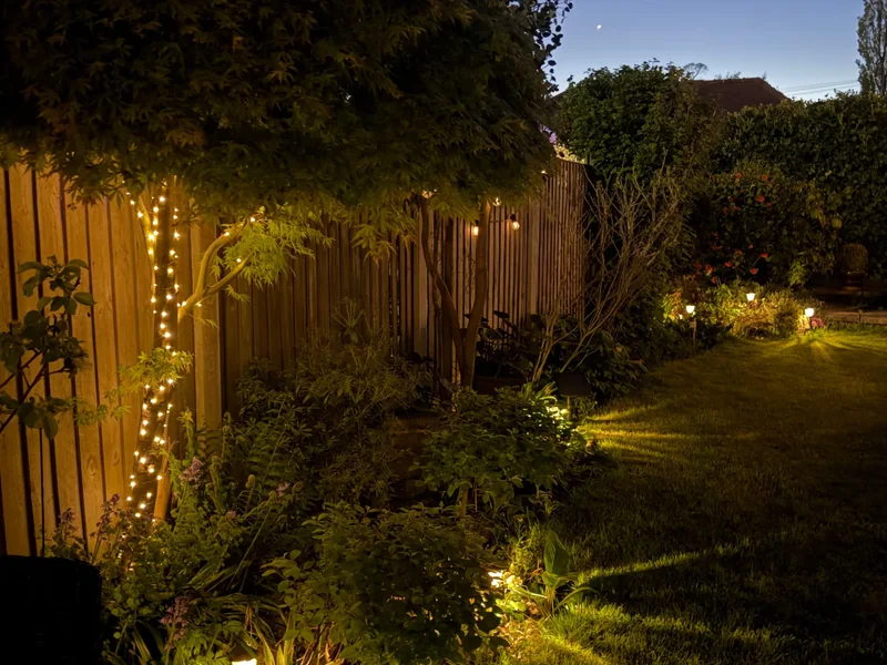Landscape lighting along a fence and garden in Franklin, TN